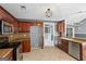 Well-lit kitchen featuring wood cabinets, stainless steel appliances, and tile flooring at 227 River Trace Ct, Mcdonough, GA 30253