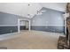 Spacious living room with stone fireplace, large windows, and neutral carpet at 227 River Trace Ct, Mcdonough, GA 30253