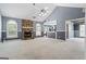 Spacious living room with stone fireplace, large windows, and neutral carpet at 227 River Trace Ct, Mcdonough, GA 30253