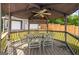 Backyard gazebo featuring a ceiling fan and a table with seating for outdoor dining at 227 River Trace Ct, Mcdonough, GA 30253