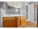 Bathroom vanity featuring double sinks, wooden cabinets, and wood-look flooring at 227 River Trace Ct, Mcdonough, GA 30253