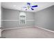 Spacious bedroom featuring neutral walls, carpet, and a modern ceiling fan at 227 River Trace Ct, Mcdonough, GA 30253