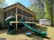 Spacious backyard featuring a large slide with a tunnel, perfect for outdoor fun and recreation at 324 Bells Ferry Ne Rd, White, GA 30184