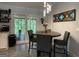 Bright dining area with modern lighting and a view of the lush backyard through sliding glass doors at 324 Bells Ferry Ne Rd, White, GA 30184