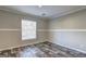Neutral bedroom featuring wood-look floors, fresh paint, and a large window at 36 Highpoint Ln, Locust Grove, GA 30248
