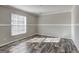 Neutral bedroom featuring wood-look floors, fresh paint, and white trim at 36 Highpoint Ln, Locust Grove, GA 30248