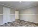 Neutral bedroom featuring wood-look floors, fresh paint, and white trim and doors at 36 Highpoint Ln, Locust Grove, GA 30248