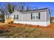 This home's exterior features gray siding, black shutters, and a well-maintained lawn at 36 Highpoint Ln, Locust Grove, GA 30248