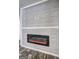 Modern electric fireplace with decorative wood paneling at 36 Highpoint Ln, Locust Grove, GA 30248