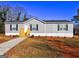 Charming single-story home featuring gray siding, black shutters, and a well-maintained front yard at 36 Highpoint Ln, Locust Grove, GA 30248