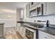 Updated kitchen with stainless steel appliances, black countertops and modern fixtures at 36 Highpoint Ln, Locust Grove, GA 30248