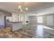 Open-plan living area with an island, fireplace, and neutral decor at 36 Highpoint Ln, Locust Grove, GA 30248