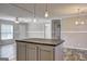 Open-concept living room featuring a kitchen island and contemporary lighting at 36 Highpoint Ln, Locust Grove, GA 30248