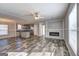 Open-concept living area showcasing a fireplace, modern flooring and an adjoining kitchen at 36 Highpoint Ln, Locust Grove, GA 30248