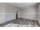 Bright living room with wood-look floors and neutral wall colors at 36 Highpoint Ln, Locust Grove, GA 30248