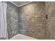 Modern shower with large stone-look tiles and rainfall shower head at 36 Highpoint Ln, Locust Grove, GA 30248