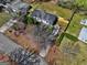An aerial view of the home with its well-kept yard, lush trees, and a neatly paved driveway at 152 Skyland E Dr, Locust Grove, GA 30248