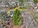 A high-angle view of the charming home surrounded by lush greenery and mature trees in a serene setting at 152 Skyland E Dr, Locust Grove, GA 30248