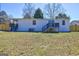 A home's backyard showcases a small deck, patio and fenced yard at 152 Skyland E Dr, Locust Grove, GA 30248