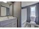 A bathroom showcases a white vanity, mirror, toilet and tub/shower at 152 Skyland E Dr, Locust Grove, GA 30248