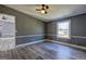 Bedroom with wood-look flooring with adjoining room and window at 152 Skyland E Dr, Locust Grove, GA 30248