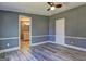 Bedroom with wood-look flooring with bathroom and closet doors at 152 Skyland E Dr, Locust Grove, GA 30248