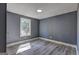 Cozy bedroom featuring wood-look flooring and a window with natural light at 152 Skyland E Dr, Locust Grove, GA 30248