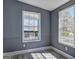 Bright bedroom featuring wood-look flooring and white trim windows with natural light at 152 Skyland E Dr, Locust Grove, GA 30248