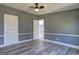 Bedroom with wood-look flooring and multiple closets and doors at 152 Skyland E Dr, Locust Grove, GA 30248