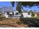 Charming single-story home featuring a covered porch and freshly painted white siding and black shutters at 152 Skyland E Dr, Locust Grove, GA 30248