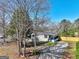 Charming home featuring a covered porch and a well-maintained front yard with mature trees at 152 Skyland E Dr, Locust Grove, GA 30248