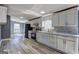 Modern kitchen with white cabinets, stainless steel appliances, and marble countertops and backsplash at 152 Skyland E Dr, Locust Grove, GA 30248