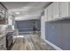 Clean kitchen with white cabinets, stainless appliances, stylish backsplash, and new vinyl floors at 152 Skyland E Dr, Locust Grove, GA 30248