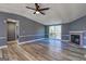 Bright open living space with sliding doors, a brick fireplace, updated lighting, and fresh paint at 152 Skyland E Dr, Locust Grove, GA 30248