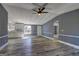 Spacious living room with new floors, fresh paint, opening to the kitchen with white cabinets and modern finishes at 152 Skyland E Dr, Locust Grove, GA 30248