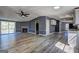Open-concept living room with fireplace, vinyl floors, sliding doors to patio, and freshly painted gray walls at 152 Skyland E Dr, Locust Grove, GA 30248