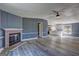 Inviting living room featuring a brick fireplace, new vinyl floors, and an open layout into the kitchen at 152 Skyland E Dr, Locust Grove, GA 30248
