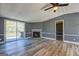 Cozy living room featuring a brick fireplace, new vinyl floors, light gray walls, and sliding doors to the deck at 152 Skyland E Dr, Locust Grove, GA 30248