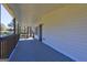 A long porch showcases white siding, a dark door and a gray floor at 152 Skyland E Dr, Locust Grove, GA 30248