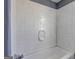 A white tiled tub/shower showcases white hardware at 152 Skyland E Dr, Locust Grove, GA 30248