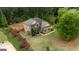 Overhead view of a landscaped home with a lush green lawn, colorful rose bushes, and mature trees at 166 Nobility Ln, Mcdonough, GA 30252