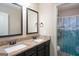 Bathroom featuring double vanity with granite countertop and a shower with a wave curtain at 166 Nobility Ln, Mcdonough, GA 30252