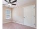 Neutral bedroom with window and a ceiling fan with light, and a door to the right at 166 Nobility Ln, Mcdonough, GA 30252