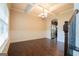 Well-lit dining room with dark hardwood floors, decorative molding and a view of the kitchen at 166 Nobility Ln, Mcdonough, GA 30252