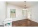 Bright dining area with a stylish chandelier and access to the backyard at 166 Nobility Ln, Mcdonough, GA 30252