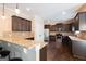 Spacious kitchen with granite countertops, dark wood cabinets, and stainless steel appliances at 166 Nobility Ln, Mcdonough, GA 30252