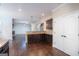 Open-concept living room with dark wood floors and seamless flow from the kitchen at 166 Nobility Ln, Mcdonough, GA 30252