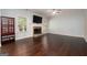 Bright living room with hardwood floors, fireplace, and large windows offering natural light at 166 Nobility Ln, Mcdonough, GA 30252