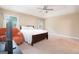 Spacious main bedroom showcasing tray ceiling, fan, and large windows, with a sitting area at 166 Nobility Ln, Mcdonough, GA 30252