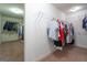 Spacious walk-in closet with rods and shelves for clothing at 166 Nobility Ln, Mcdonough, GA 30252